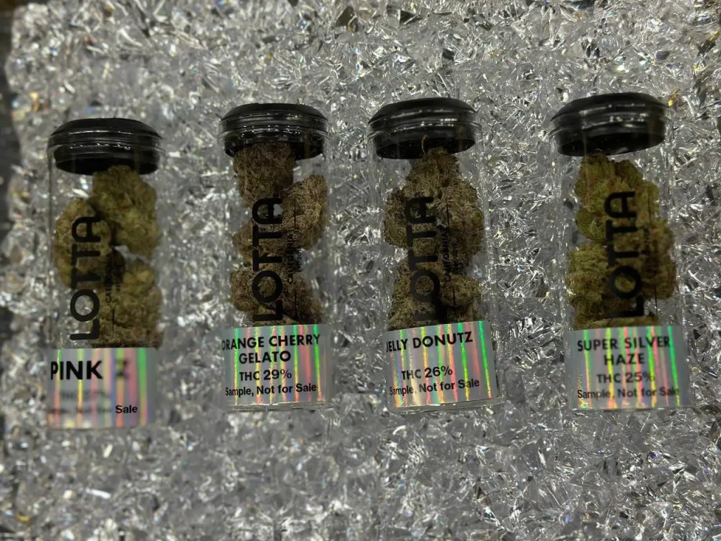 Lotta Farms cannabis flower jars with strain labels